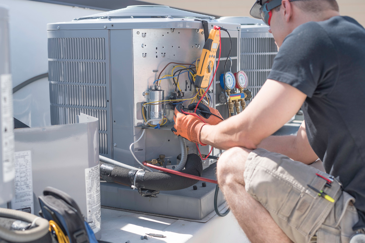 A professional performing AC repair on an outdoor AC unit in North Fort Myers.