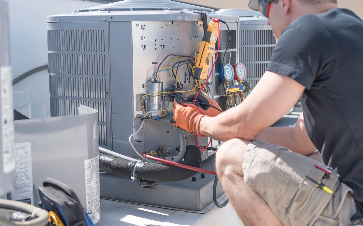 A professional performing AC repair on an outdoor AC unit in North Fort Myers.
