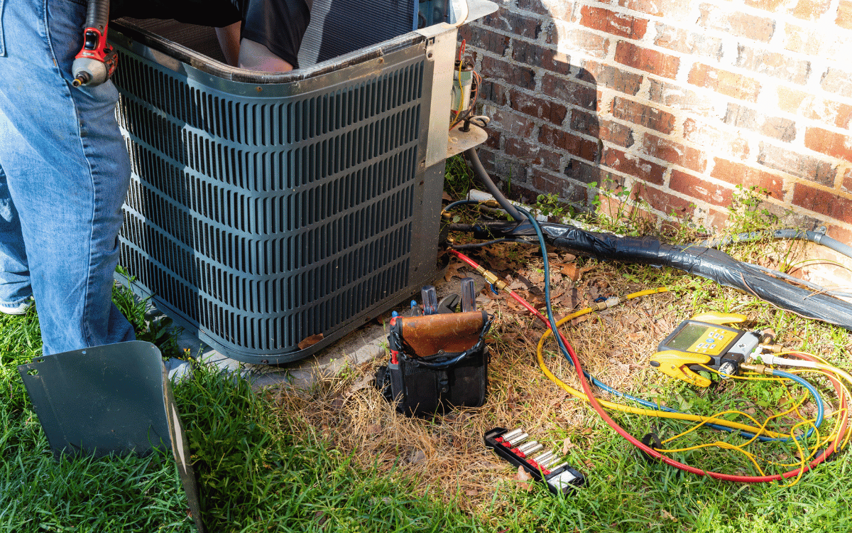 Technician repairing an AC unit