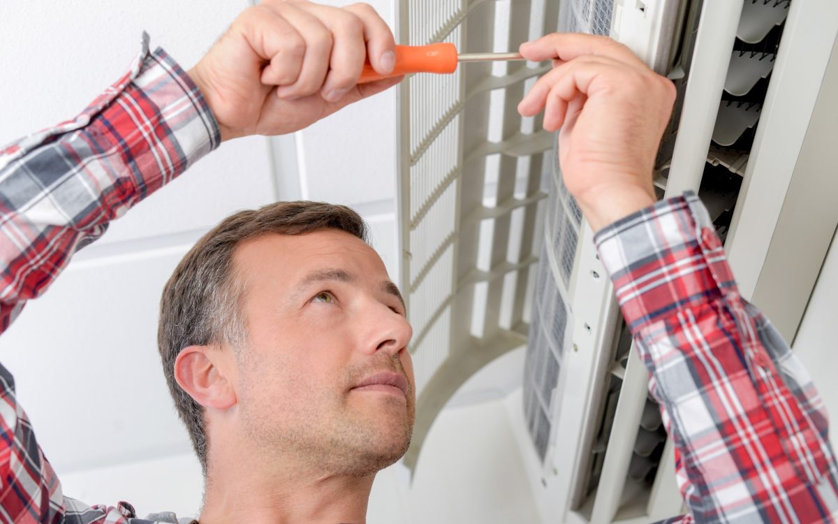 Man performing ac Maintenance on a ductless mini split ac